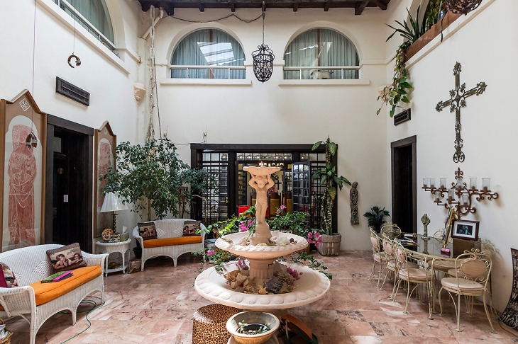 The central courtyard, around which the two-story adobe structure was built, is a serene focal point for the hacienda with marble floors, a burbling fountain, a shuttered skylight and overlooking windows from bedrooms.